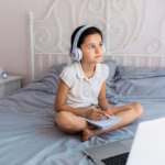 lovely-little-girl-using-her-laptop_23-2148001673